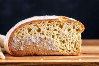 رغيف خبز مقطع يظهر قشرته الذهبية والقوام الداخلي مع تلميح لرائحة خميرية